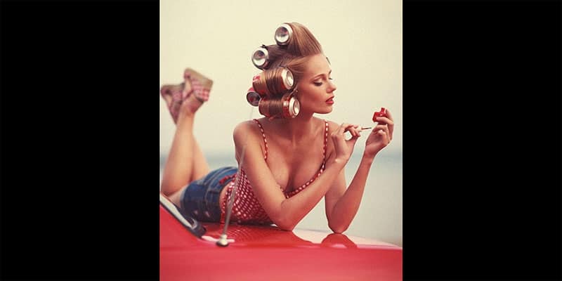 photo of a pin-up girl on top of a car