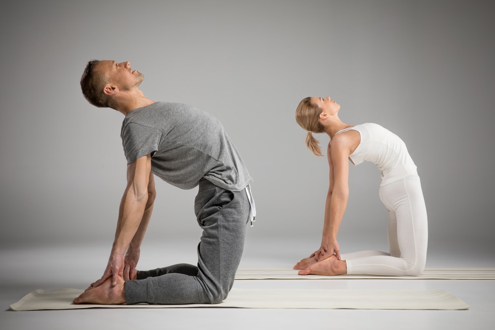 photo of two people doing a yoga pose