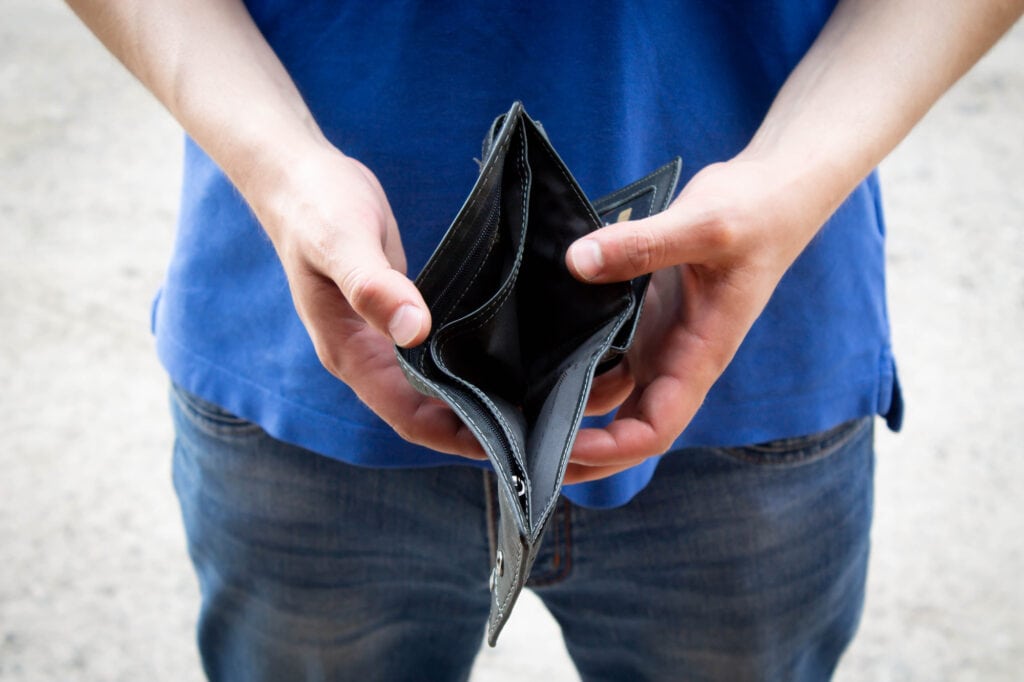 photo of a person showing their wallet empty not having a lot of money