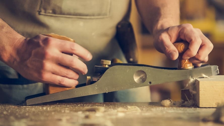 Carpentry medium, a carpenter working on wood