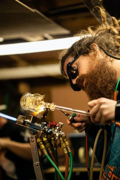 man working with glass, glassblowing