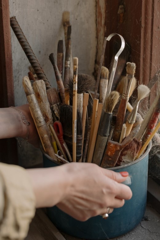 bucket of art tools, showing materiality in art